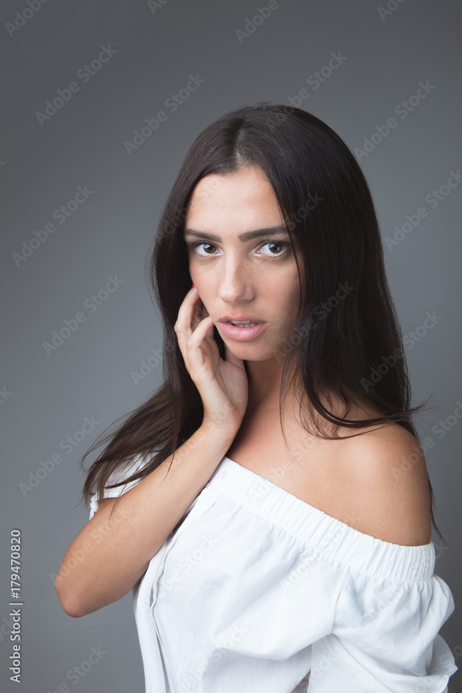white Caucasian brunette girl female model attractive fit skinny sexy beautiful posing on studio grey background white shirt portrait white Caucasian brunette girl female model attractive fit skinny sexy beautiful posing on studio grey background white shirt portrait