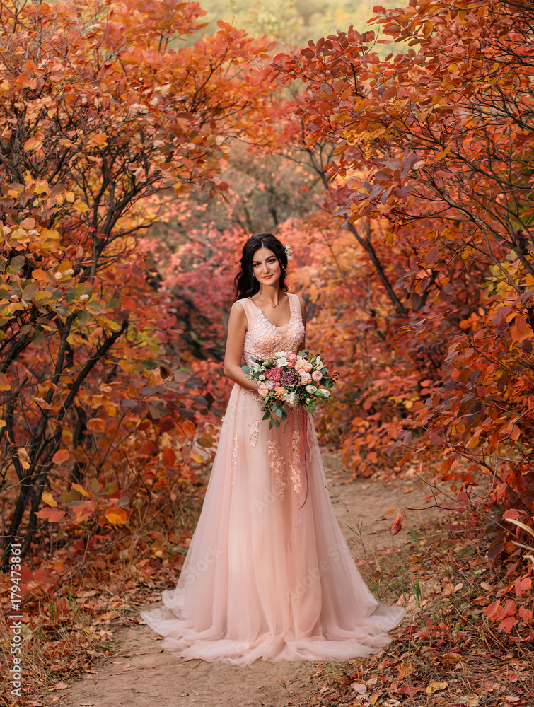 A happy bride in a beautiful, powdery dress. Wedding walk in the fairy, autumn forest A happy bride in a beautiful, powdery dress. Wedding walk in the fairy, autumn forest
