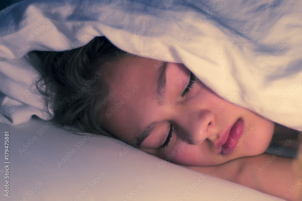 Sleeping Beauty, peeping out from under the blanket. Sleep without a pillow under the blanket. Sleek dreams in a soft bed. Good morning (night) or sweet dreams Sleeping Beauty, peeping out from under the blanket. Sleep without a pillow under the blanket. Sleek dreams in a soft bed. Good morning (night) or sweet dreams