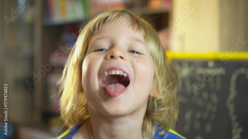 little girl shows tongue
