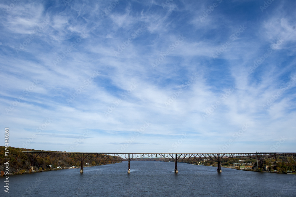 Bridge over Hudson River under big blue sky with high clouds