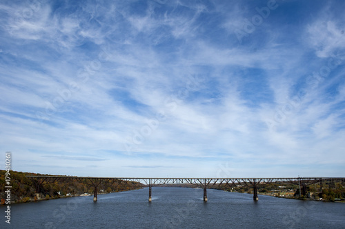 Bridge over Hudson River under big blue sky with high clouds