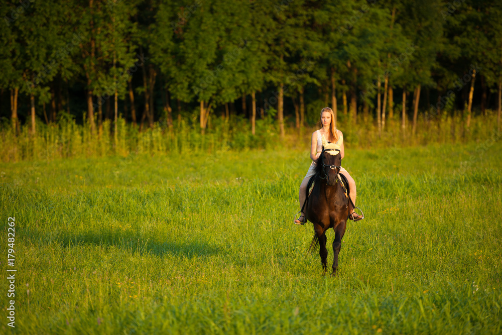 Active young woman ride a horse in nature Active young woman ride a horse in nature