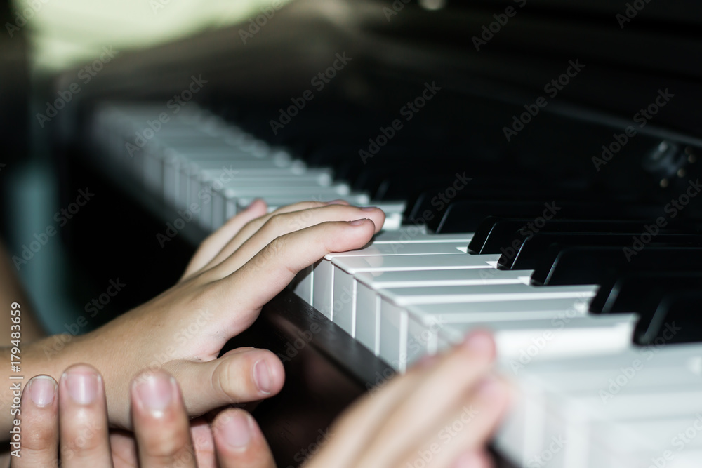 Fototapeta premium kid hands learning to play piano