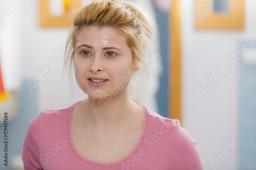 Young woman having gel mask on face