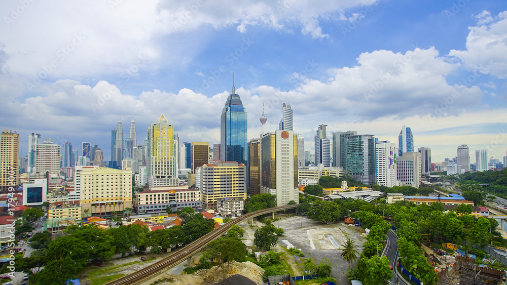 Fototapeta premium Kuala Lumpur city skyline during summer with dramatic blur sky at background.