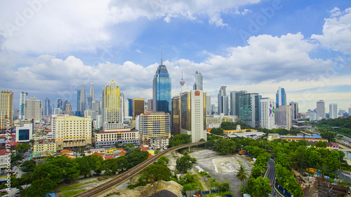Kuala Lumpur city skyline during summer with dramatic blur sky at background.