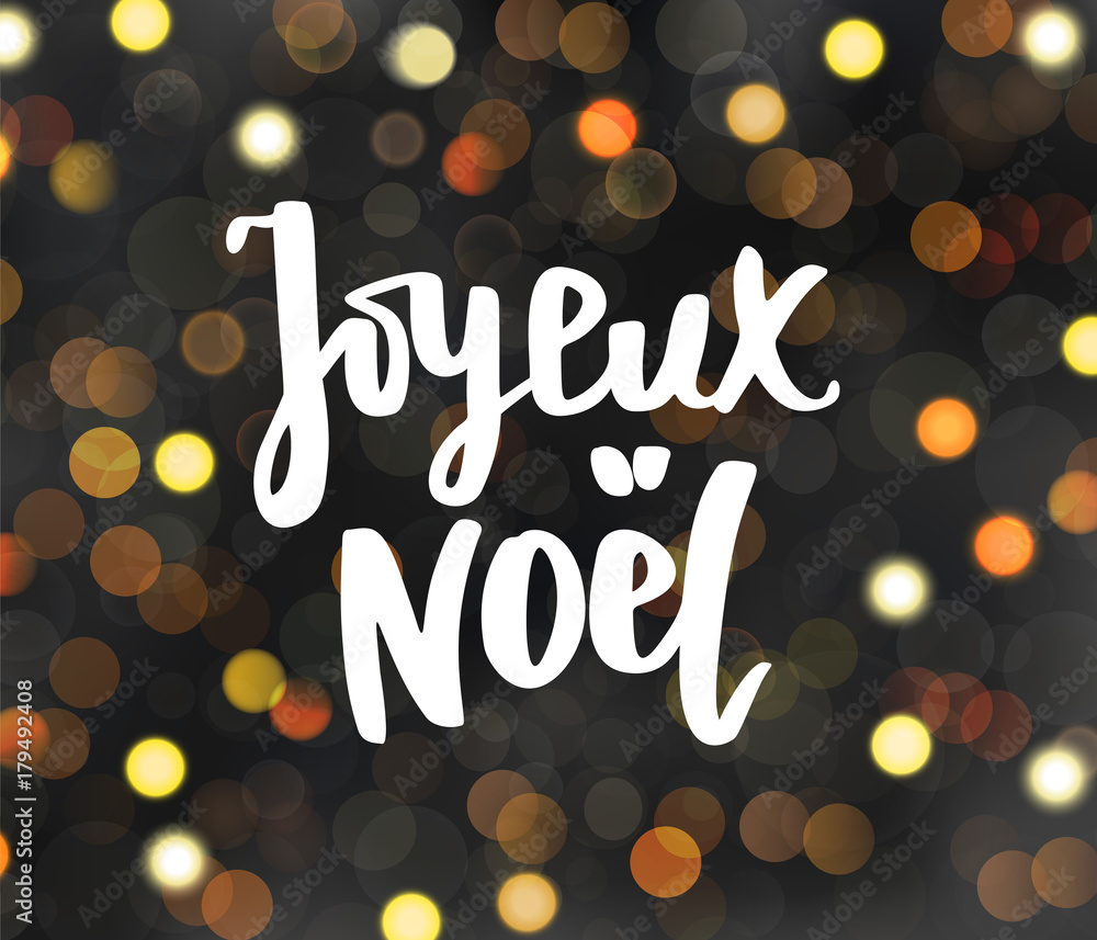 Joyeux noel text. Holiday greetings. Merry Christmas french quote. Glowing lights on dark blurred background.