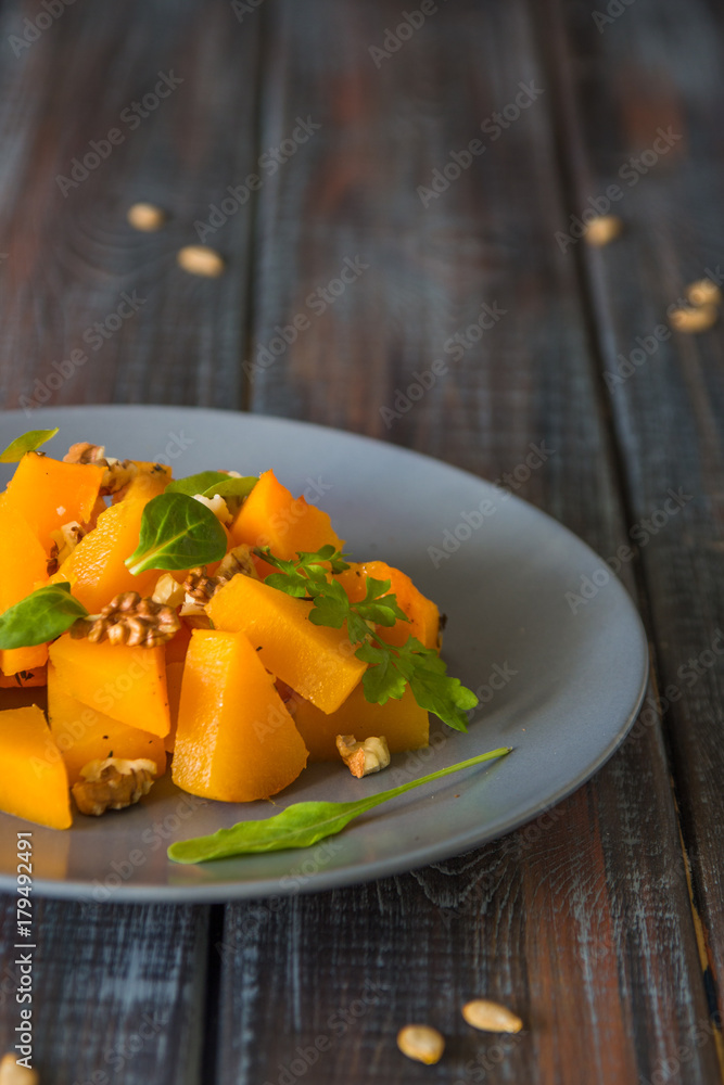 Salad with pumpkin, walnuts and green leaves Salad with pumpkin, walnuts and green leaves