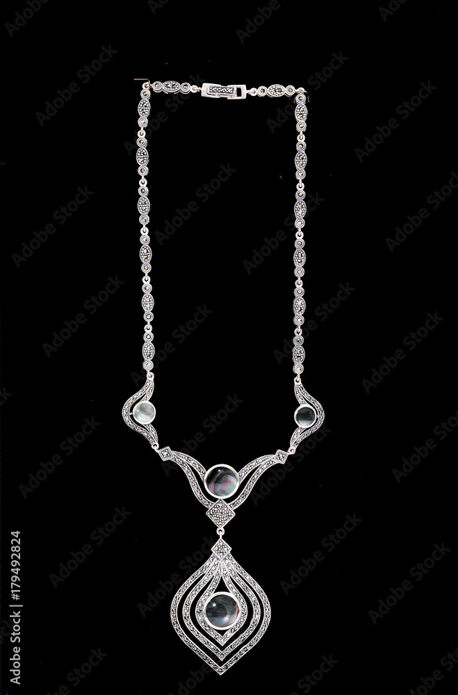 necklace with diamonds on a black background necklace with diamonds on a black background