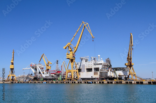 port cranes in the harbour of cadiz, spain
