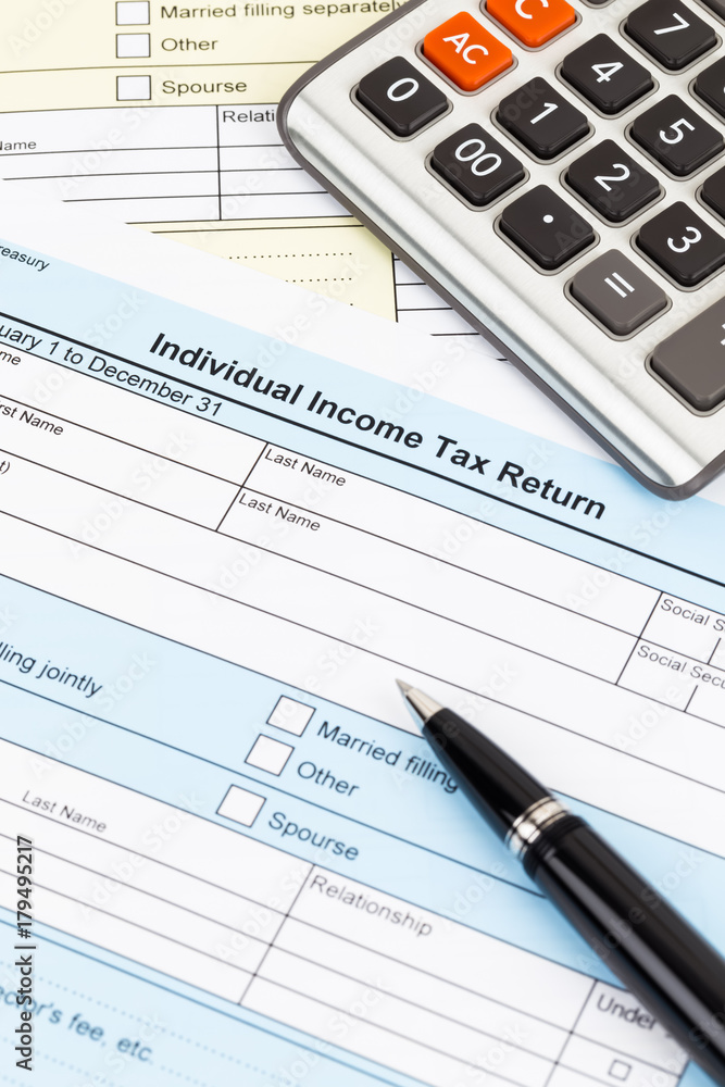 Tax form with pen and calculator; document are mock-up Tax form with pen and calculator; document are mock-up