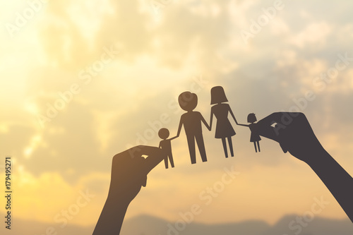 silhouette hand holding paper of family