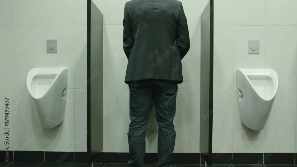 Man peeing to toilet bowl in restroom. Long shot vídeo de Stock | Adobe Stock
