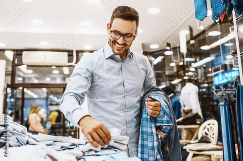 Smiling Young Man Buying Clothes