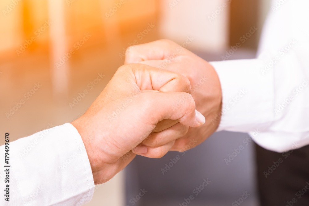 Asian business people giving fist bump successful deal partnership