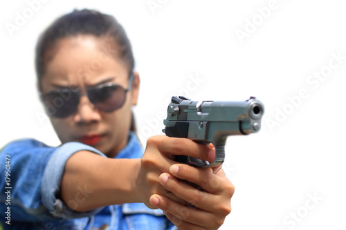 the woman in jeans suit at the shooting range shot from a revolvers,isolated on white background © toodtuphoto