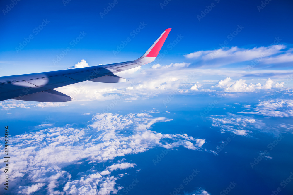 Clouds and sky as seen through window of an aircraft Clouds and sky as seen through window of an aircraft