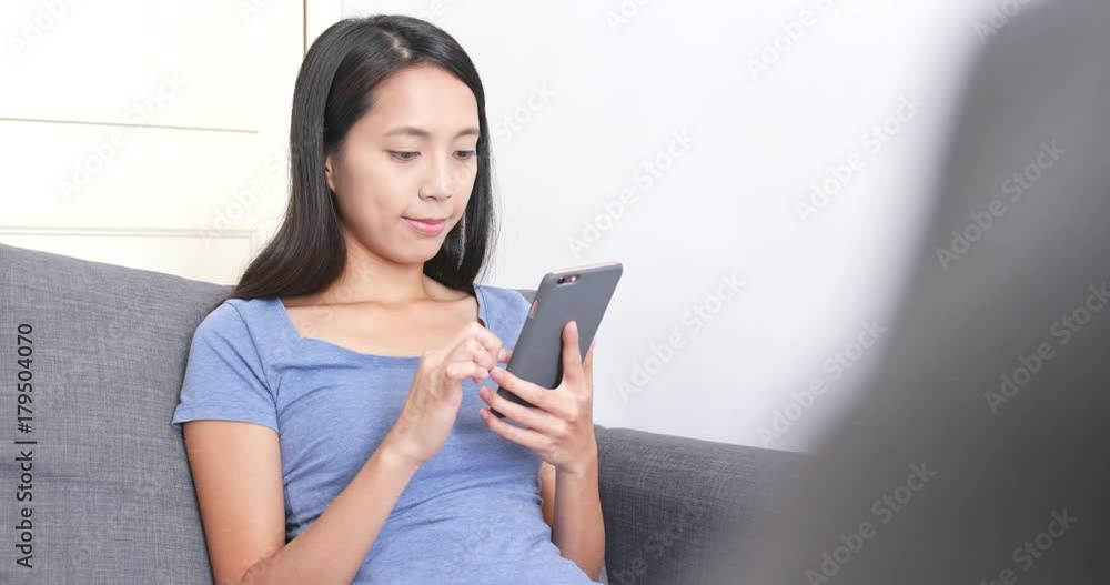 Woman using cellphone at home Woman using cellphone at home