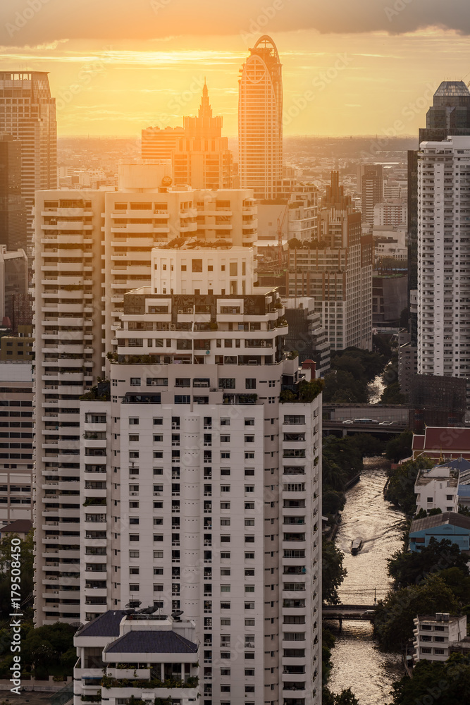 Naklejka premium aerial cityscape view of Saen Saep canal and boat service at sunset in Bangkok, Thailand with sunlight effect