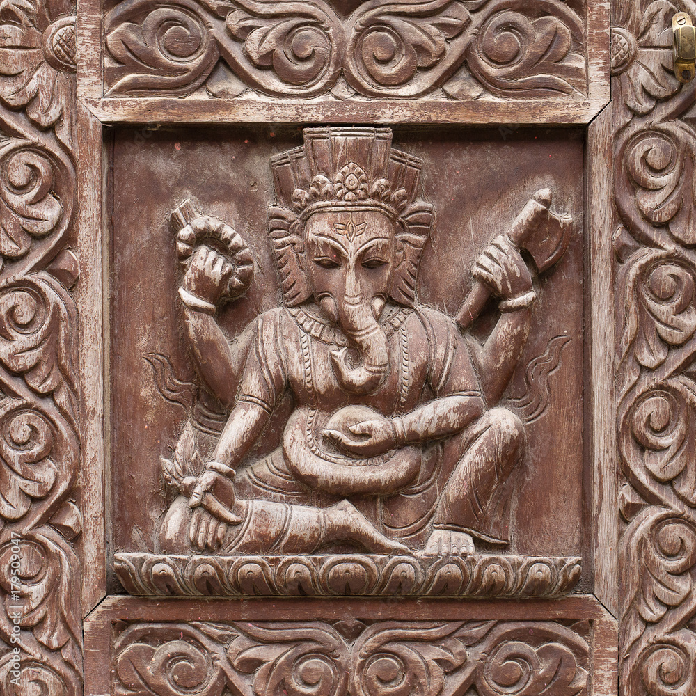 Detail wooden carved door in hindu temple, Kathmandu, Nepal background. Vintage antique door with ornament