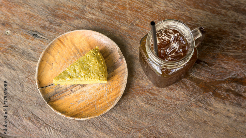 Green tea brownie and ice americano on a wooden table. Green tea brownie and ice americano on a wooden table.
