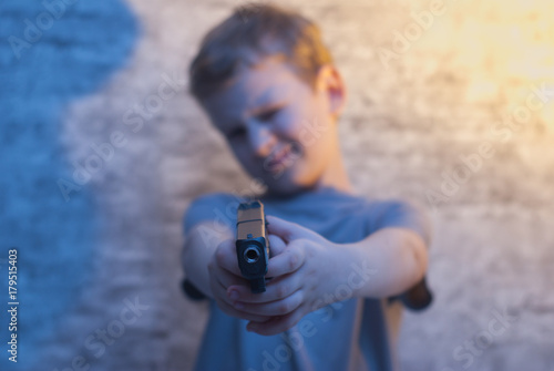 the boy with the gun pointing,