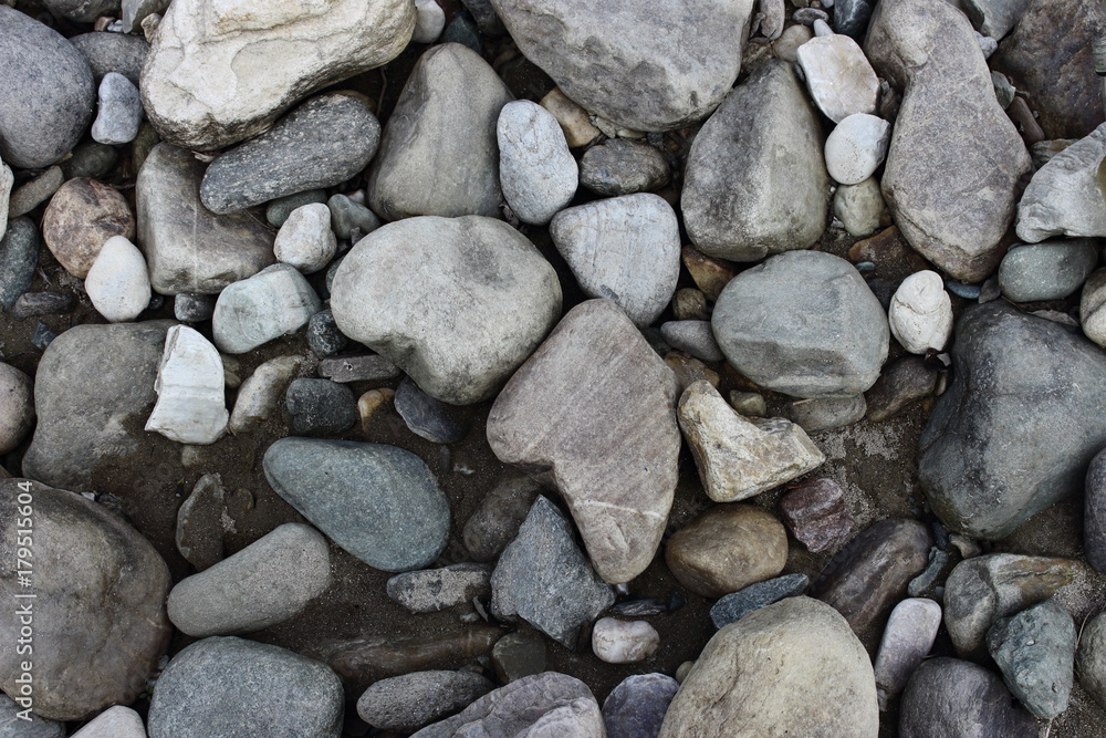 Grey and white stones on river beach as stone background texture. Grey and white stones on river beach as stone background texture.