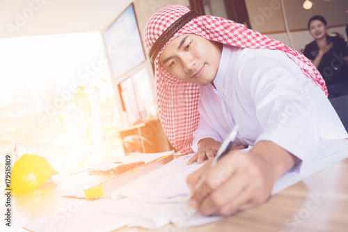 business arabian man working with paper and document on wooden table business concept