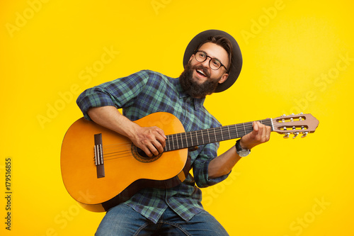 Cheerful musician with guitar photo