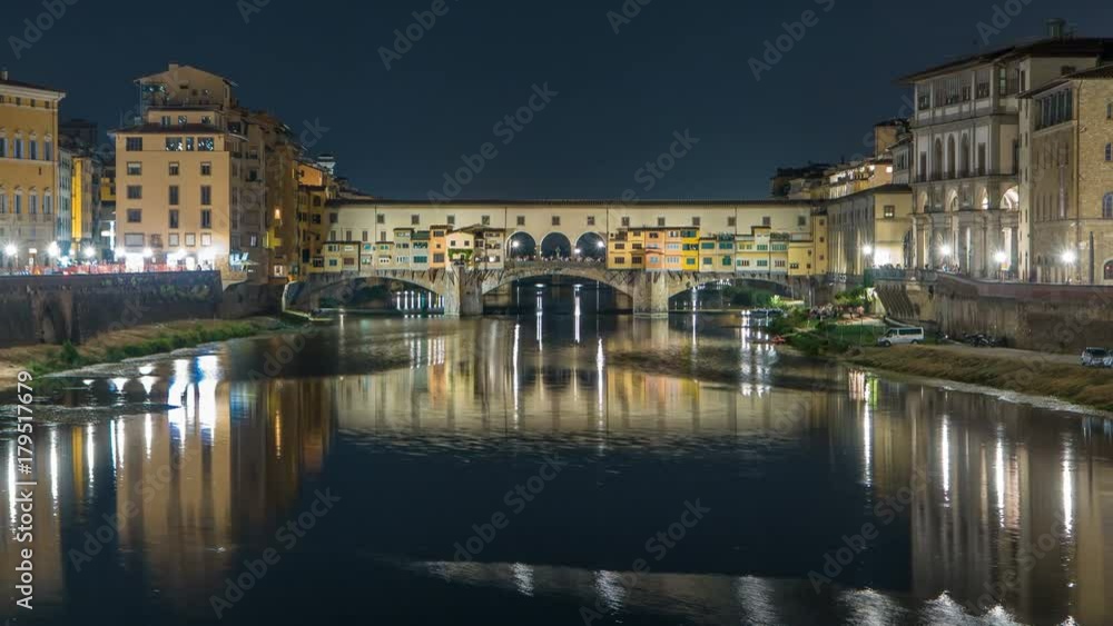 Famous Ponte Vecchio bridge timelapse over the Arno river in Florence, Italy, lit up at night Famous Ponte Vecchio bridge timelapse over the Arno river in Florence, Italy, lit up at night