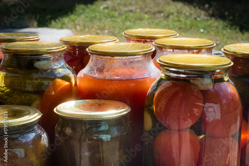 Jars with variety of pickled vegetables. Preservation photo