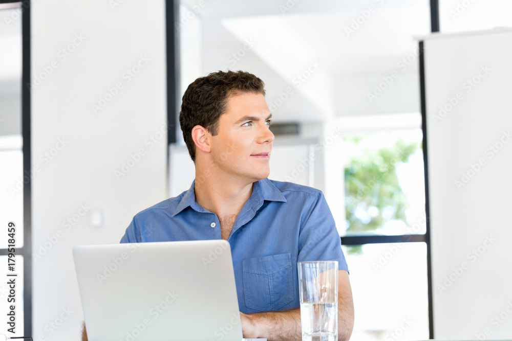 Fototapeta premium Handsome businessman working at computer
