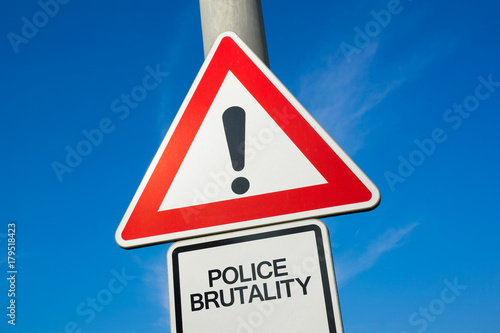 Fényképezés Police brutality - traffic sign with exclamation mark to alert, warn caution - p