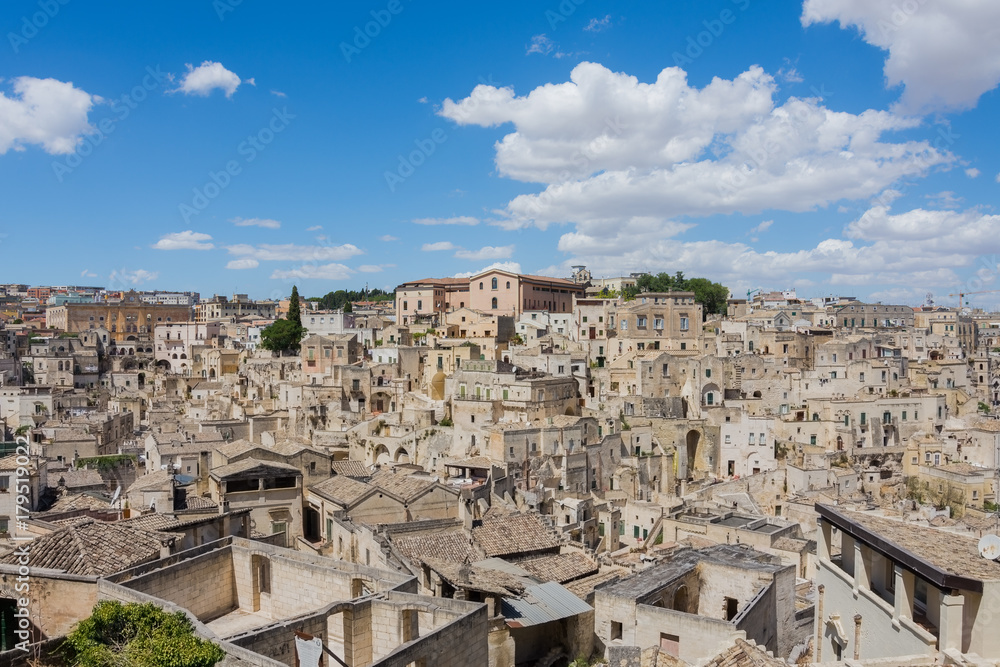 Panoramic view of the ancient town of Matera (Sassi di Matera), European Capital of Culture 2019, under blue sky, Basilicata, southern Italy