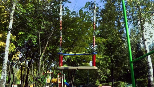 Loneli swings swing on the playground. photo