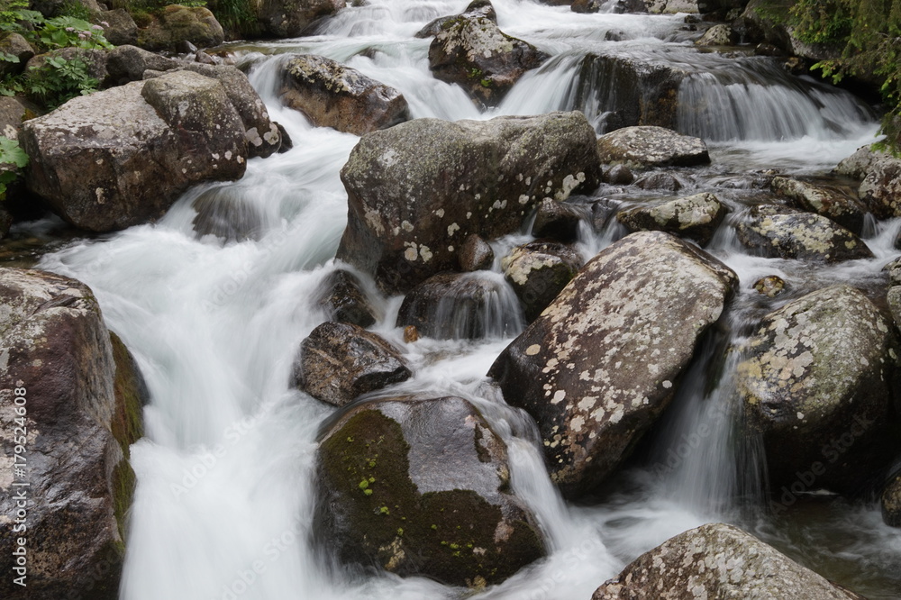 Nature in High Tatras in Slovakia. Mountains of rocky rocks cliffs and waterfalls suitable as background pictures of wishes, banners.