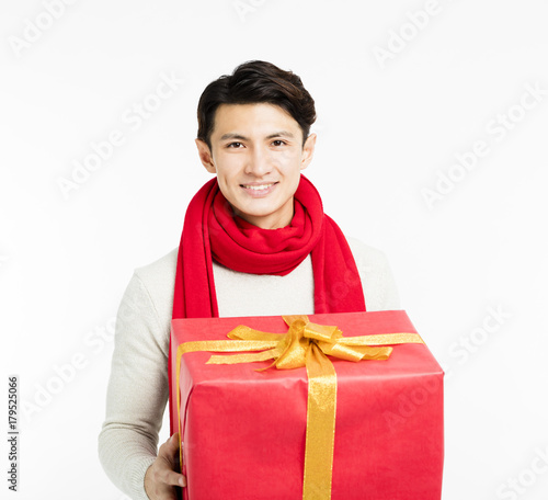 happy young man showing christmas gifts