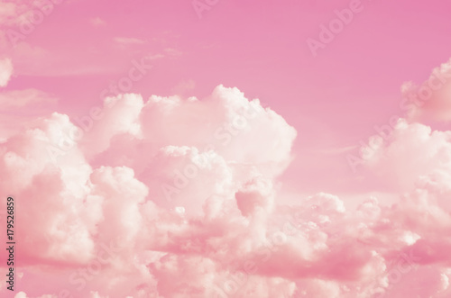 Pink sky background with white clouds.