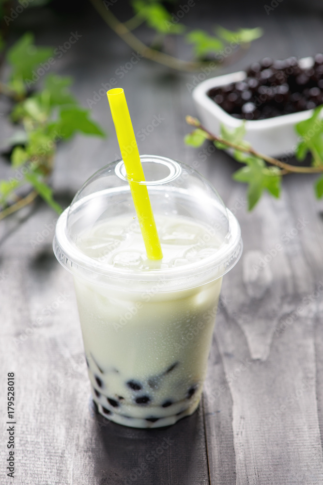 Homemade milk bubble tea in plastic cups on table. Homemade milk bubble tea in plastic cups on table.