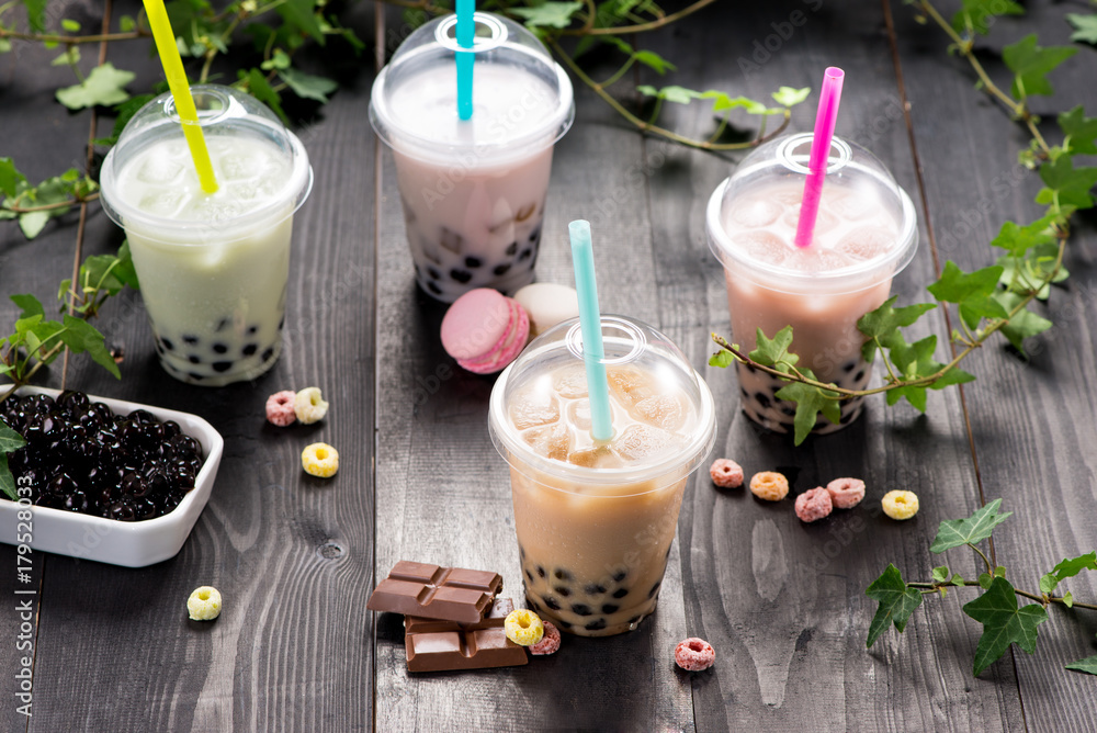 Milky bubble tea with tapioca pearls in plastic cup Milky bubble tea with tapioca pearls in plastic cup