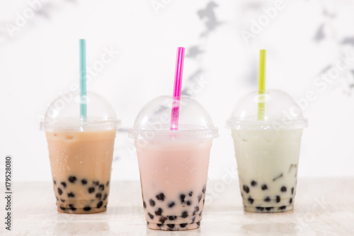 Fefreshing iced milky bubble tea with tapioca pearls in plastic cup