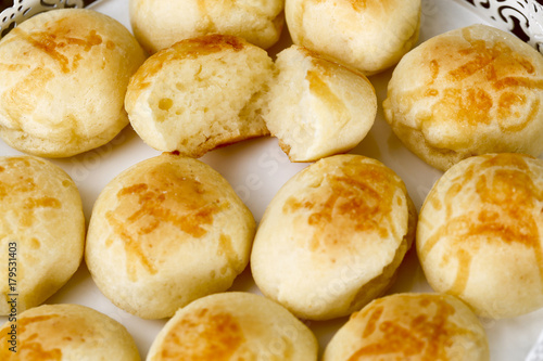 Portion of the famous Brazilian cheese bread on white tray photo