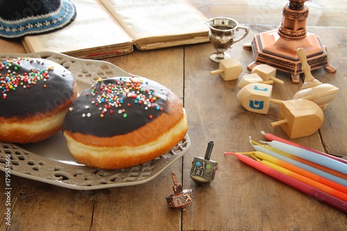 image of jewish holiday Hanukkah background with traditional spinnig top and doughnuts.
