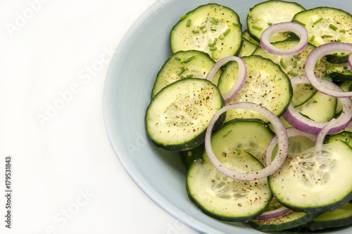 Cucumber salad with red onion and ground pepper.