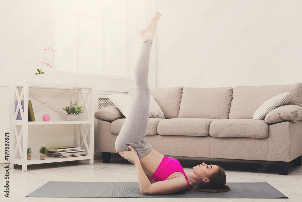 Fototapeta premium Woman training yoga in shoulder stand pose.