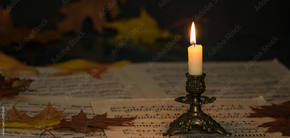 Fototapeta premium candle and sheet music