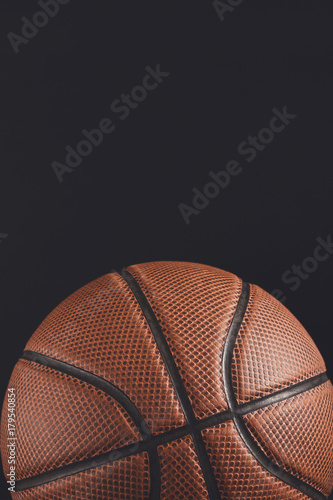 Old basketball ball on black background copy space