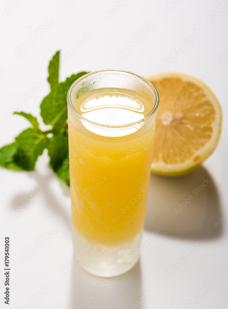 Traditional homemade lemon liqueur limoncello and fresh citrus Traditional homemade lemon liqueur limoncello and fresh citrus