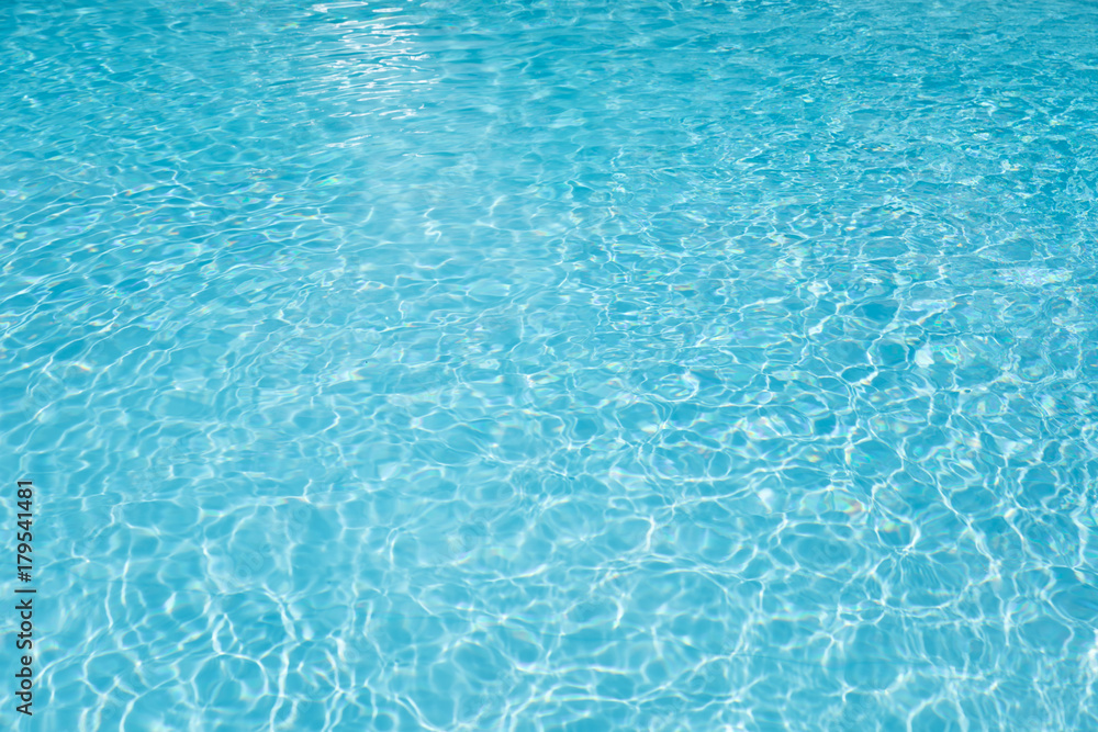 Blue and bright water surface and ripple wave in swimming pool